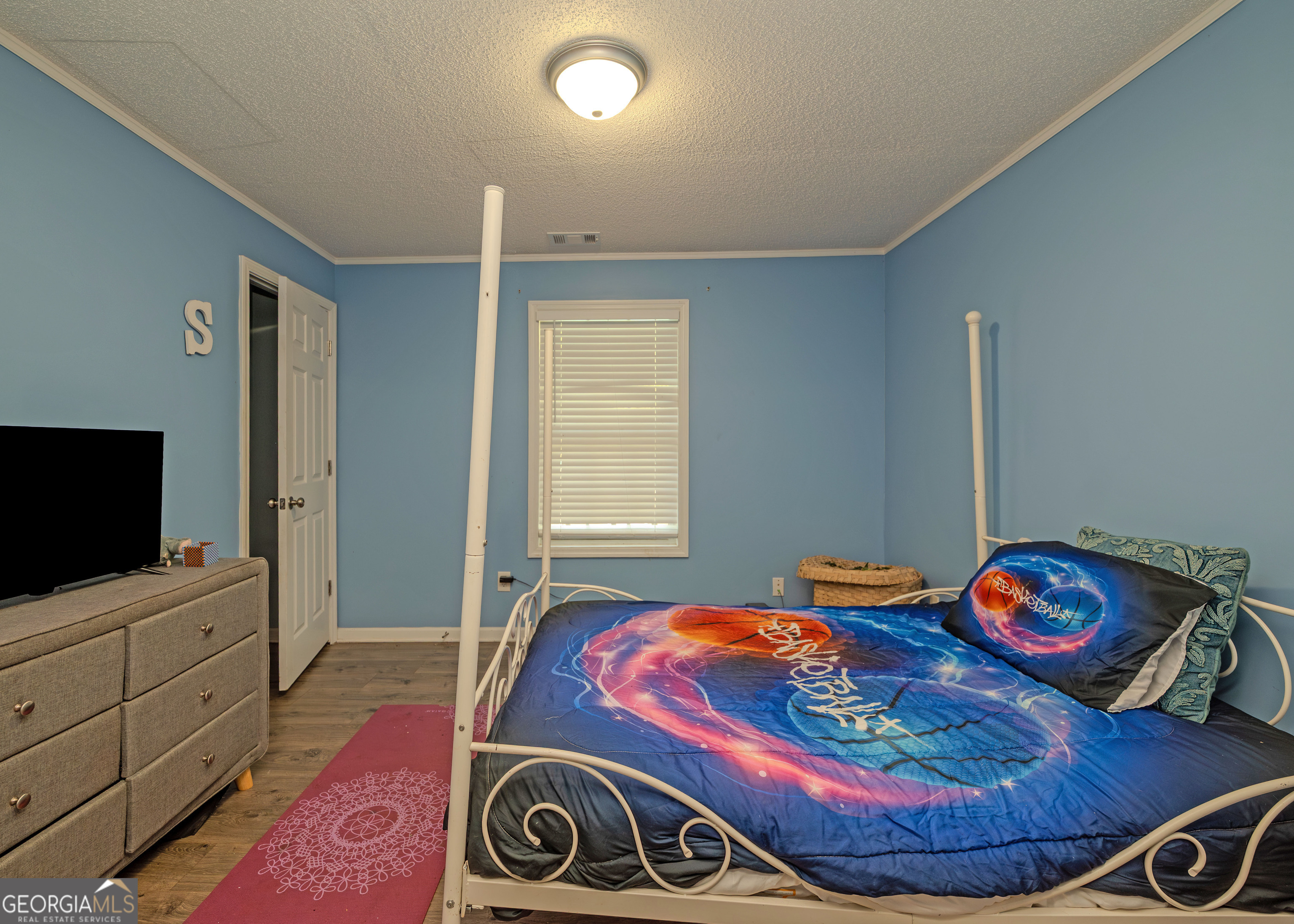 87 Little Milltown Road Hartwell, GA 30643 - Photo 31 of 39 a bedroom with filled bed and a flat screen tv