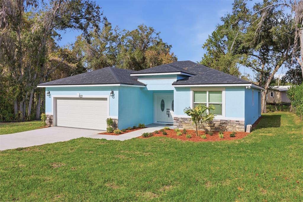 822 Poplar Street Inverness, FL 34452 - Photo 1 of 45 a front view of a house with garden
