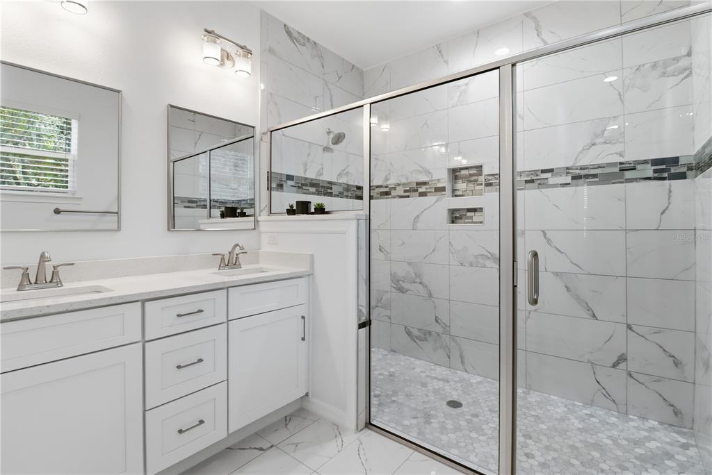 822 Poplar Street Inverness, FL 34452 - Photo 18 of 45 a bathroom with a shower sink and mirror