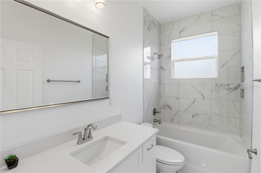 822 Poplar Street Inverness, FL 34452 - Photo 24 of 45 a bathroom with a sink toilet and shower