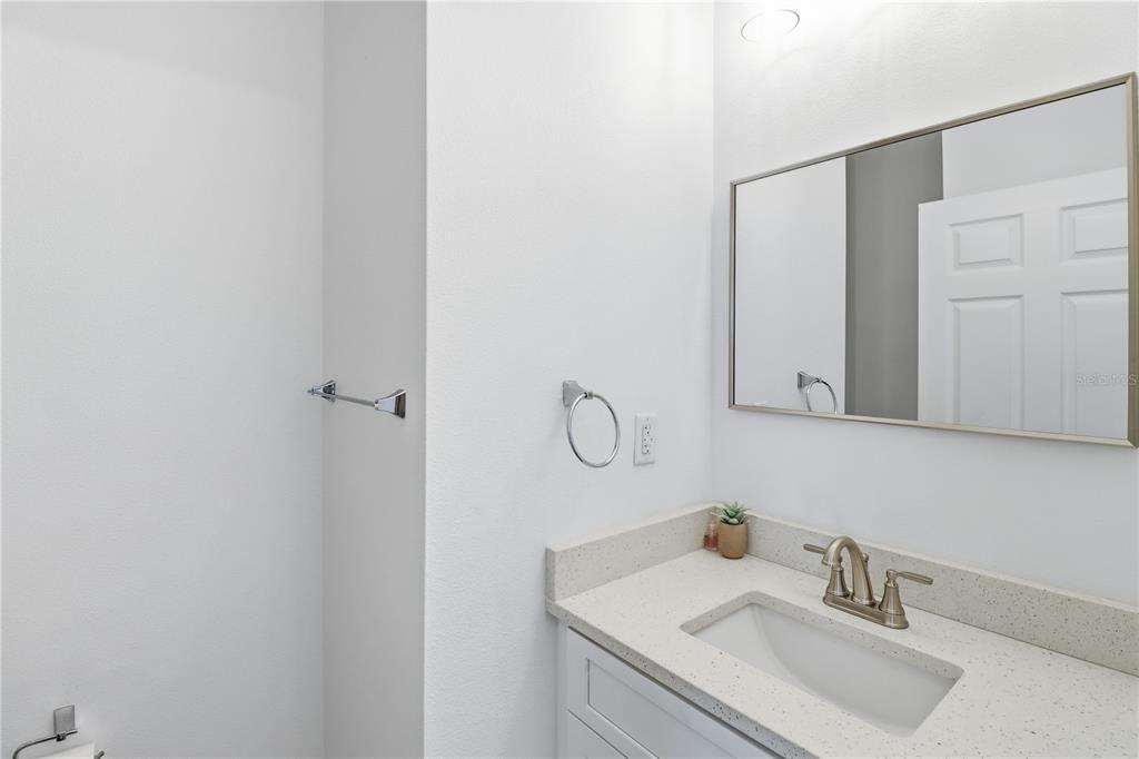 822 Poplar Street Inverness, FL 34452 - Photo 25 of 45 a bathroom with a sink and a mirror