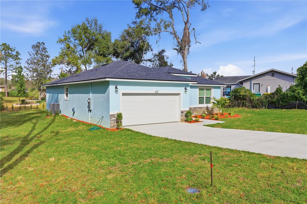 822 Poplar Street Inverness, FL 34452 - Photo 33 of 45 a front view of a house with a yard and garage