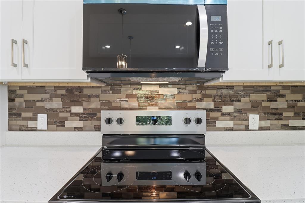 822 Poplar Street Inverness, FL 34452 - Photo 8 of 45 a kitchen with a stove and cabinets