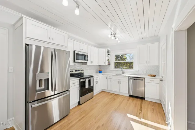 a view of a room with wooden floor