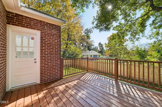 a balcony with wooden floor and fence