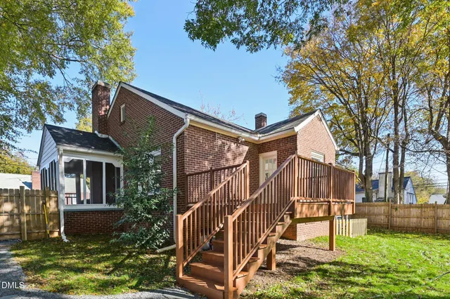a view of a yard with wooden fence