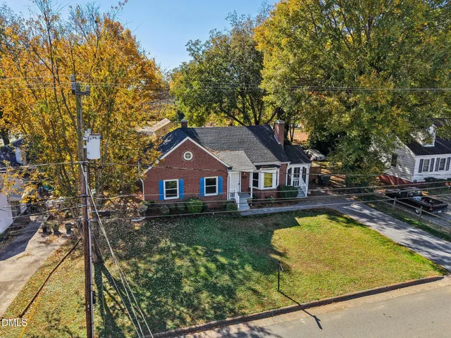 a aerial view of a house with swimming pool next to a yard