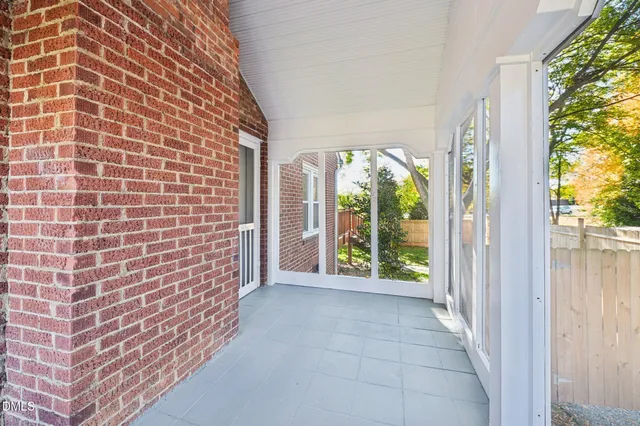 a view of a brick house with large windows