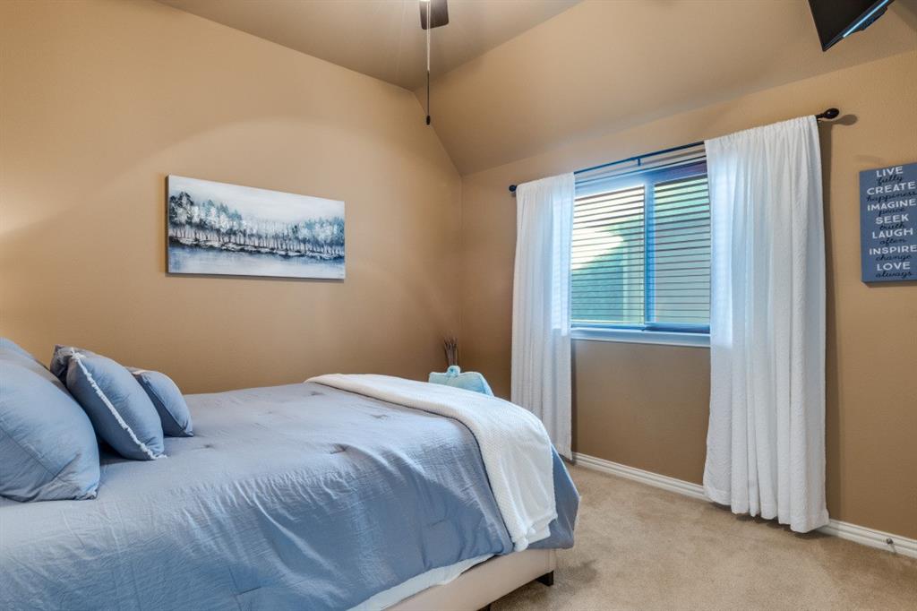 2810 Baker Street Sachse, TX 75048 - Photo 16 of 26 Bedroom with carpet, a ceiling fan, and vaulted ceiling