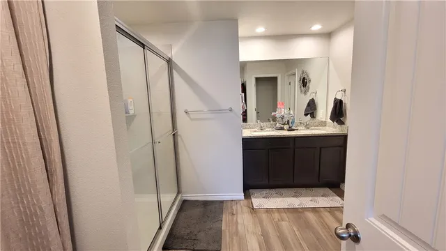 a bathroom with a sink a mirror and a shower
