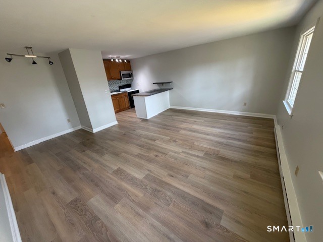 239 Old Farms Road, Unit 16D Avon, CT 06001 - Photo 14 of 16 an empty room with wooden floor and appliances