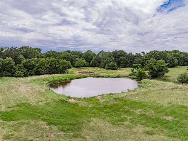a view of a swimming pool and a yard