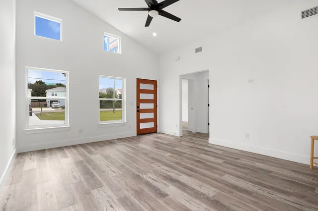a kitchen with kitchen island wooden floor center island and stainless steel appliances