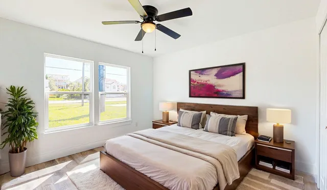 an aerial view of residential houses with outdoor space and trees