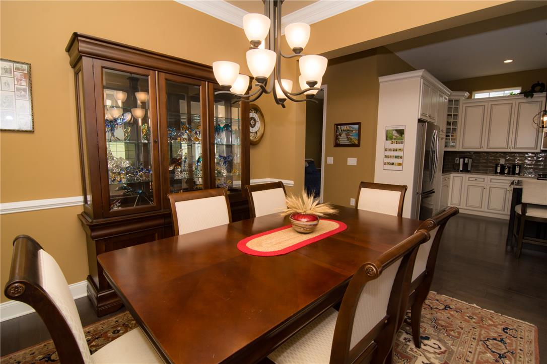 4097 Rutz Lane Allentown, PA 18104 - Photo 22 of 59 Crown molding and rich hardwood flooring enhance this formal dining space open to the kitchen.