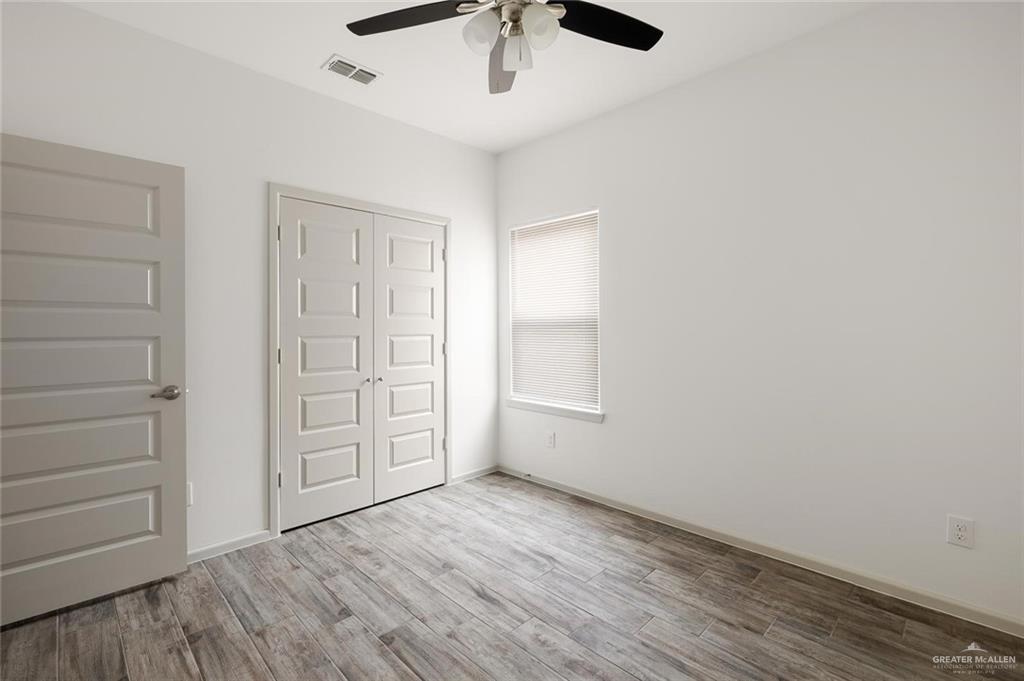 1024 Palm Drive, Unit 1 Alamo, TX 78516 - Photo 6 of 9 wooden floor in an empty room