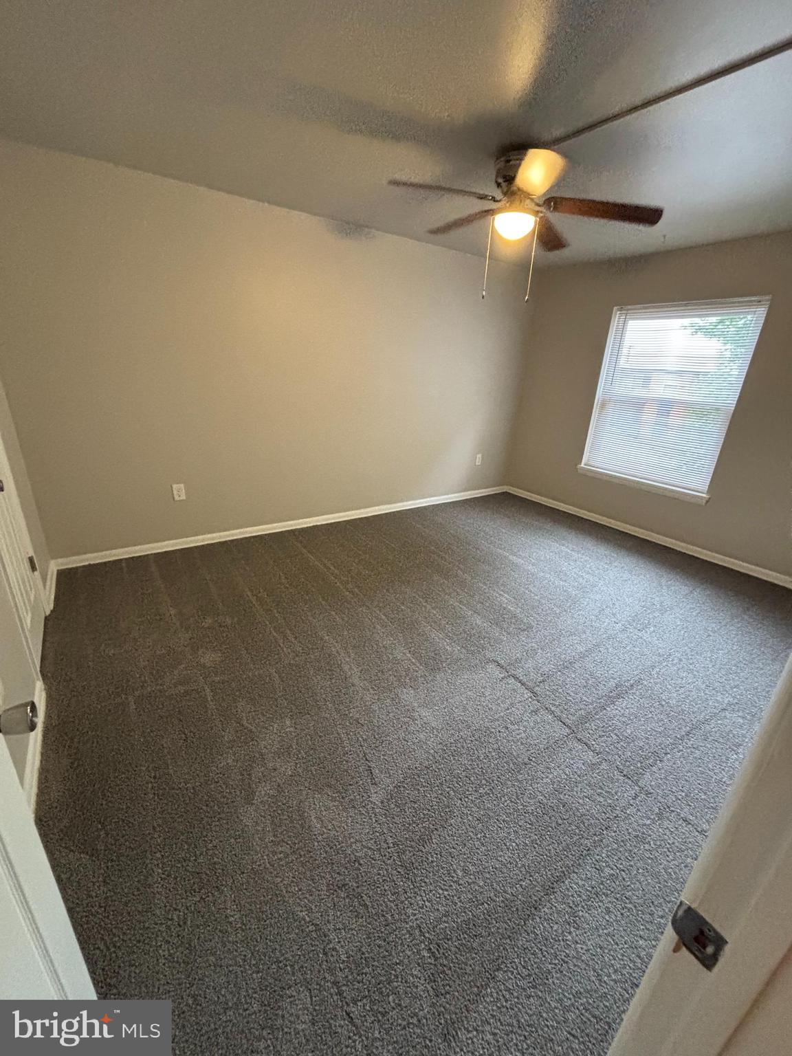 3853 St Barnabas Road, Unit 202 Suitland, MD 20746 - Photo 11 of 20 en empty room with windows and ceiling fan