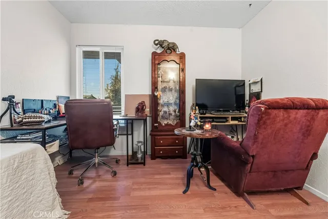 a view of a workspace with furniture and a window