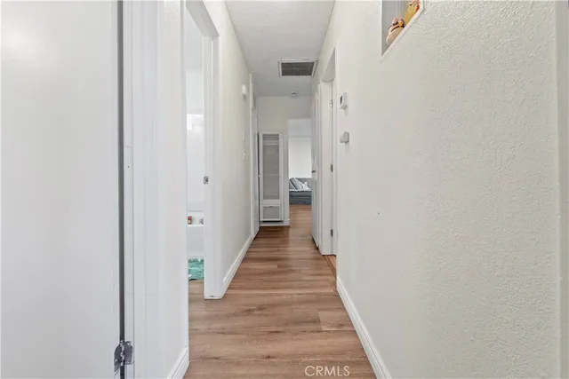 a view of a hallway with wooden floor