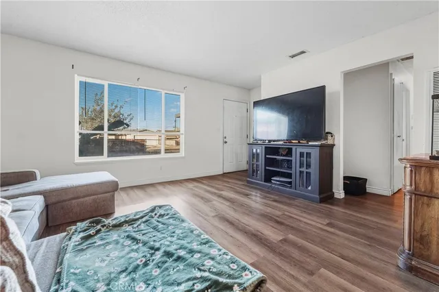 a view of a livingroom with furniture and a flat screen tv