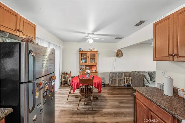 a view of a kitchen with granite countertop a sink appliances and cabinets