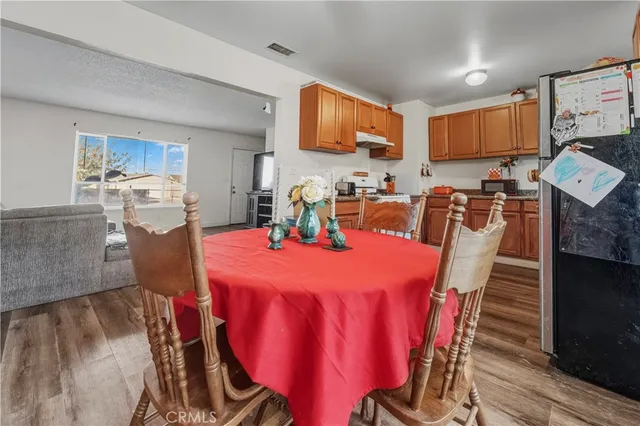 a dining room with furniture and wooden floor
