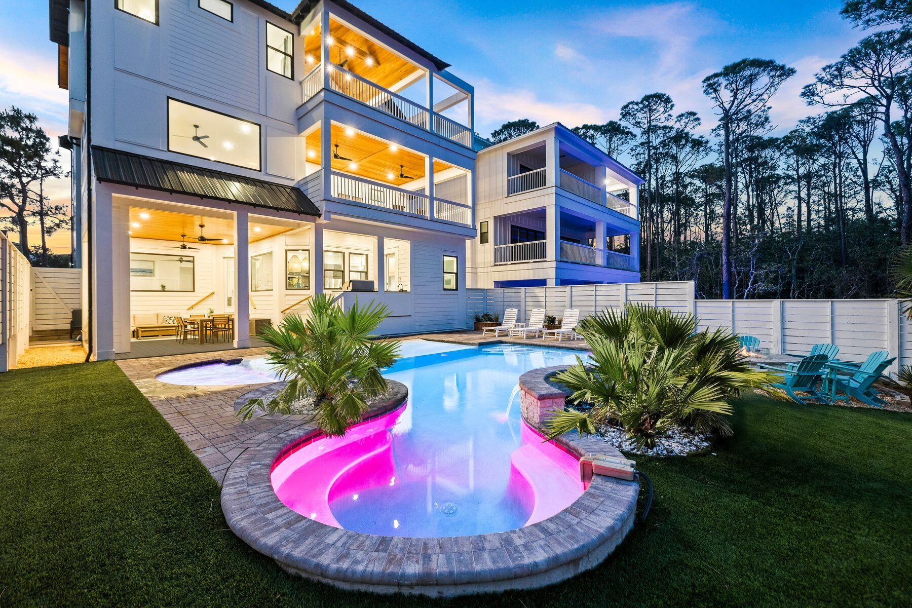 58 Santa Clara Street Santa Rosa Beach, FL 32459 - Photo 1 of 49 a view of a house with a swimming pool lawn chairs and a yard