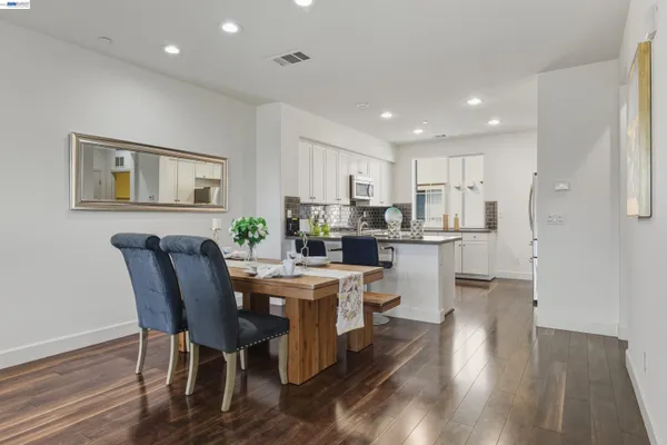 a kitchen with kitchen island wooden cabinets and stainless steel appliances