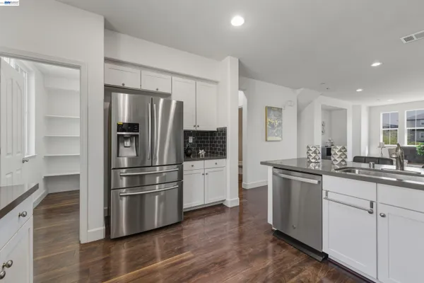 a kitchen with stainless steel appliances a refrigerator stove and sink