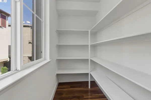 a view of walk in closet with empty racks