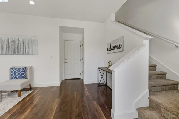 a view of entryway and hall with wooden floor