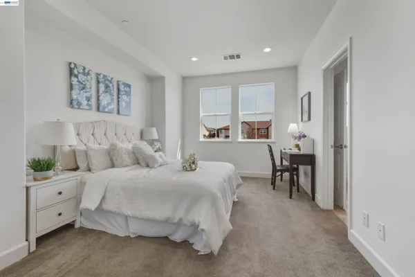 a bedroom with a bed and a table