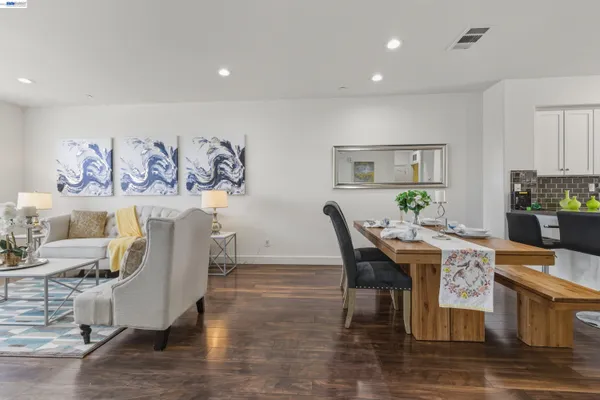 a view of a dining room with furniture and wooden floor