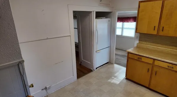 a kitchen with a refrigerator and a stove