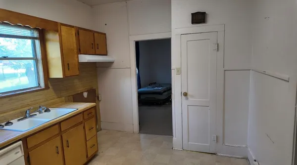 a utility room with cabinets washer and dryer
