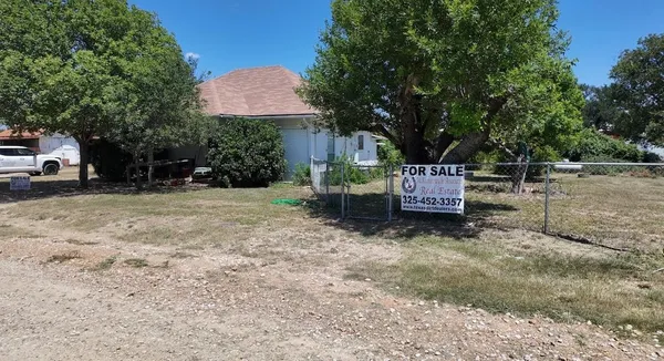 a backyard of a house with a yard and outdoor seating