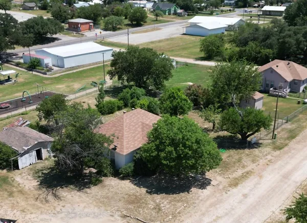 an aerial view of a house with garden space and street view