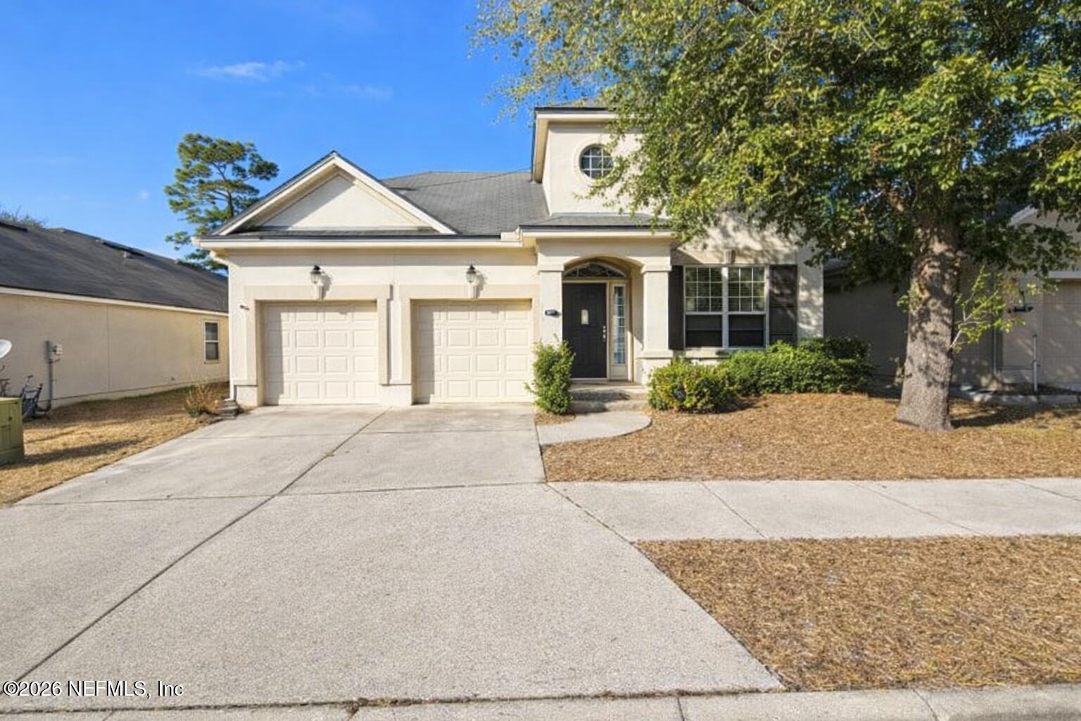 217 Amber Ridge Road Jacksonville, FL 32218 - Photo 1 of 42 a front view of a house with a yard and garage