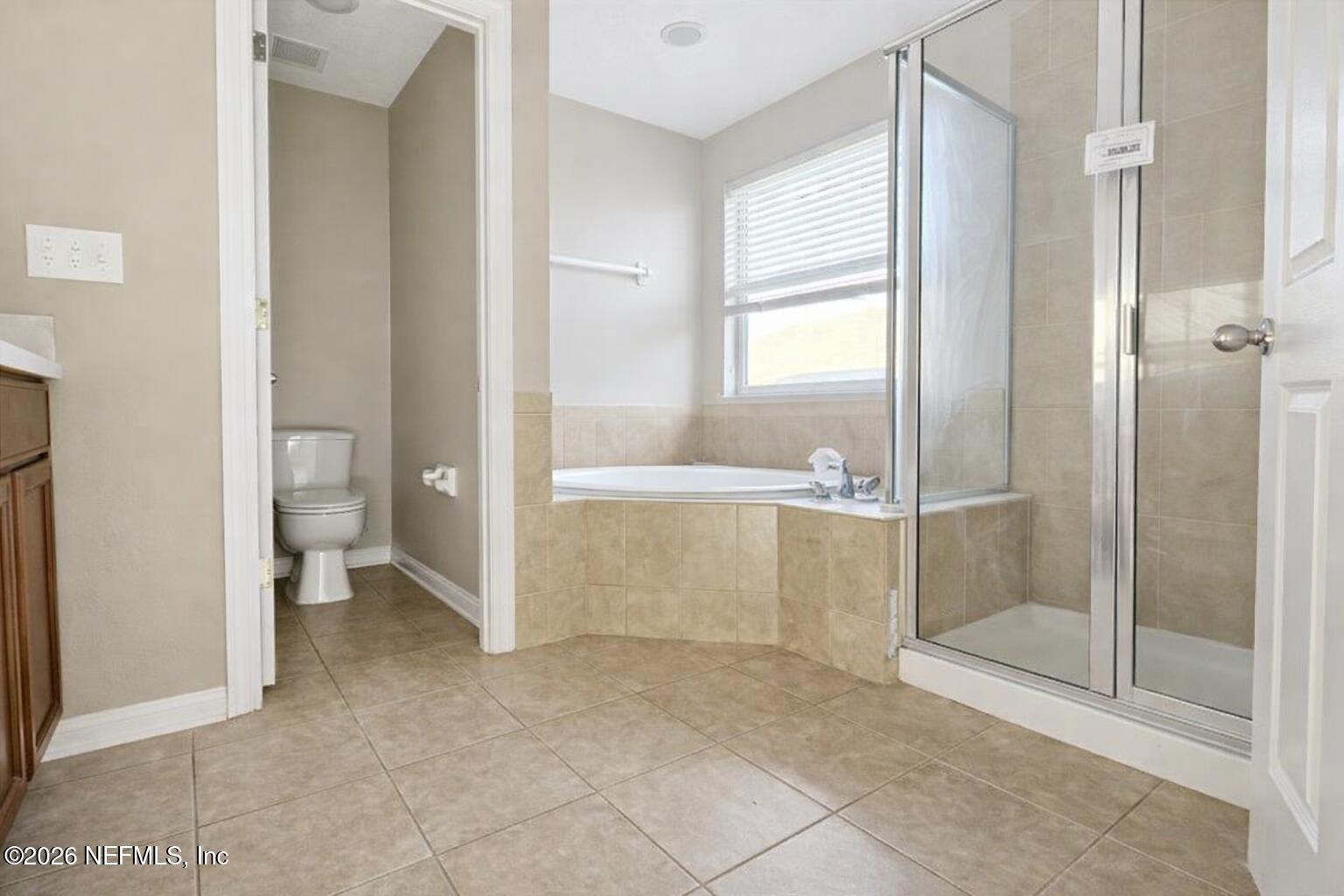 217 Amber Ridge Road Jacksonville, FL 32218 - Photo 11 of 42 a bathroom with a glass shower door and a toilet