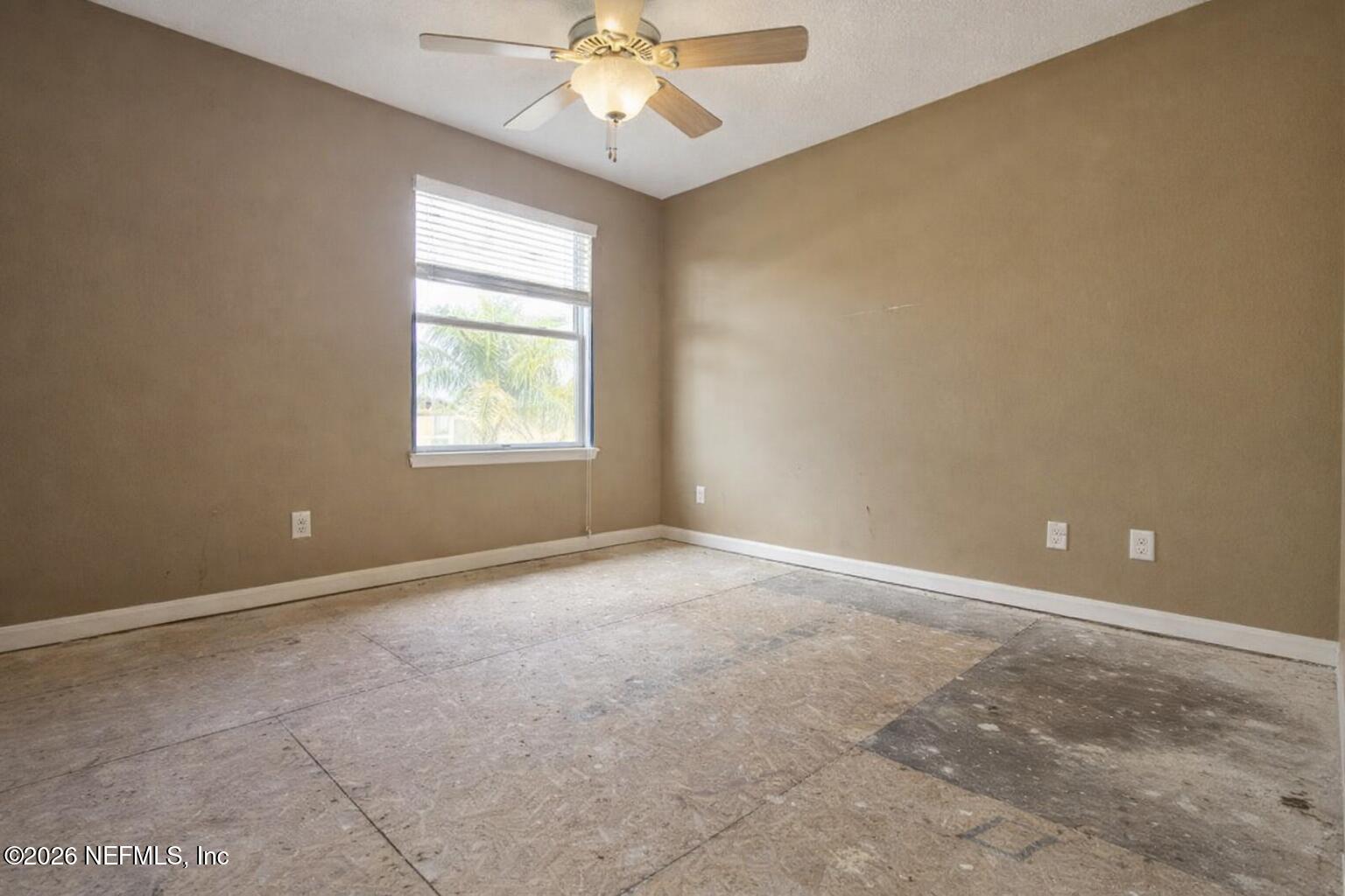 217 Amber Ridge Road Jacksonville, FL 32218 - Photo 12 of 42 an empty room with windows and fan