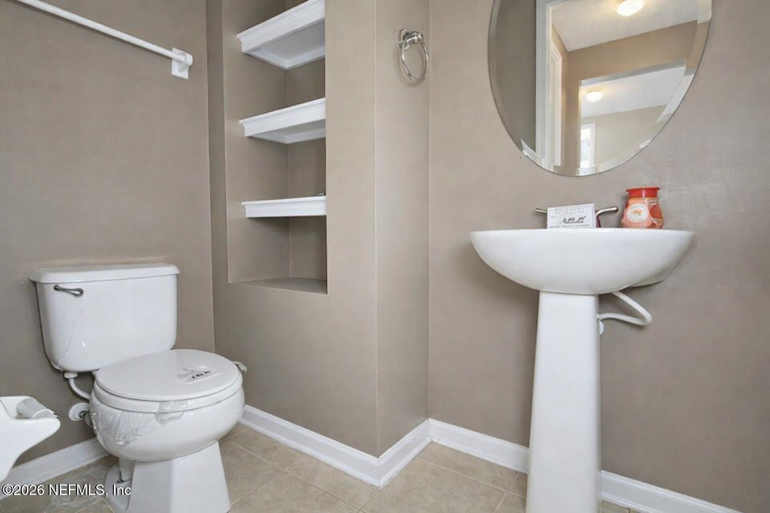 217 Amber Ridge Road Jacksonville, FL 32218 - Photo 15 of 42 a bathroom with a toilet sink and mirror