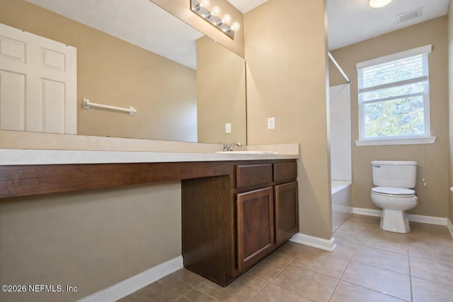 217 Amber Ridge Road Jacksonville, FL 32218 - Photo 17 of 42 a bathroom with a sink a toilet and a mirror