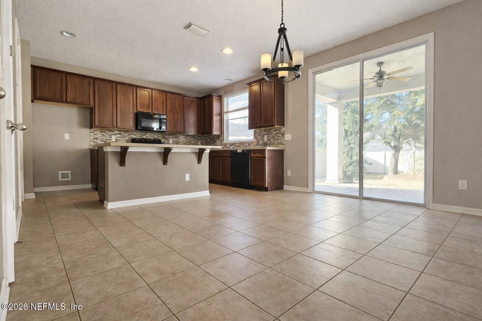 217 Amber Ridge Road Jacksonville, FL 32218 - Photo 20 of 42 a kitchen with stainless steel appliances granite countertop a refrigerator and a sink