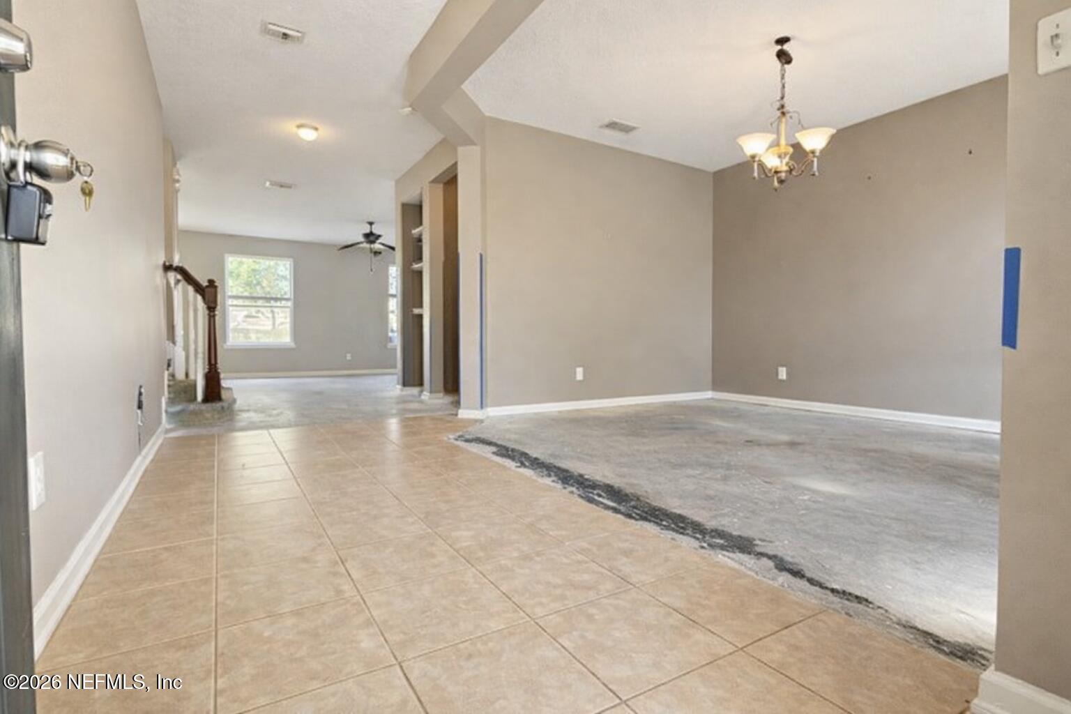 217 Amber Ridge Road Jacksonville, FL 32218 - Photo 26 of 42 a view of a hallway with a chandelier