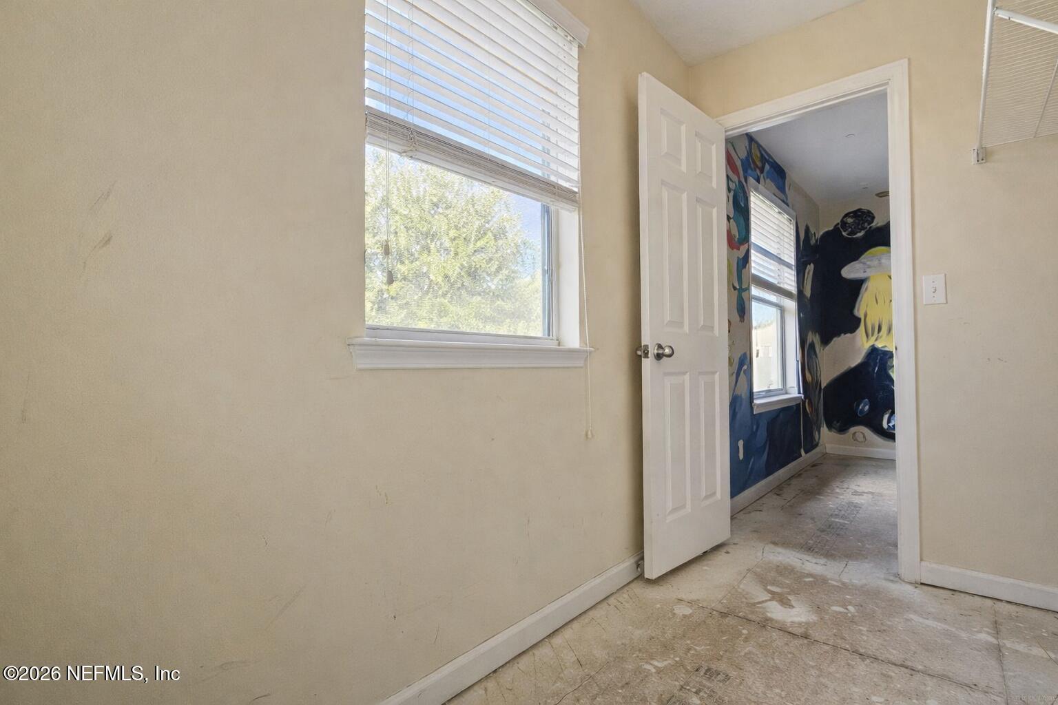 217 Amber Ridge Road Jacksonville, FL 32218 - Photo 32 of 42 an empty room with a window and a bathroom