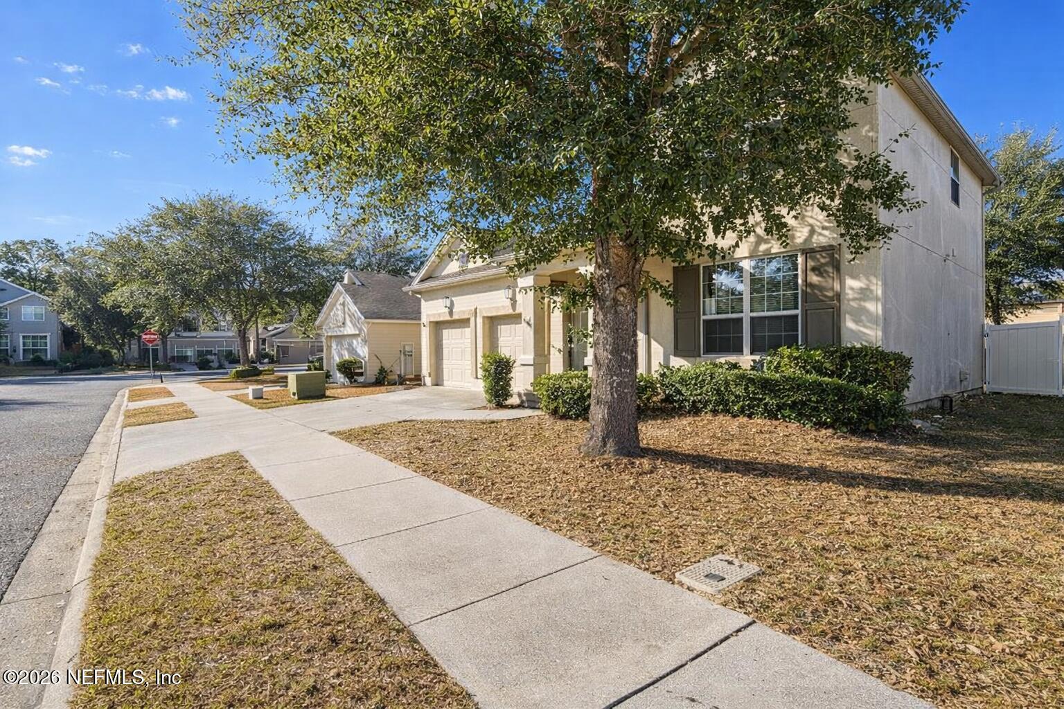 217 Amber Ridge Road Jacksonville, FL 32218 - Photo 38 of 42 a view of a white house with a large tree and plants