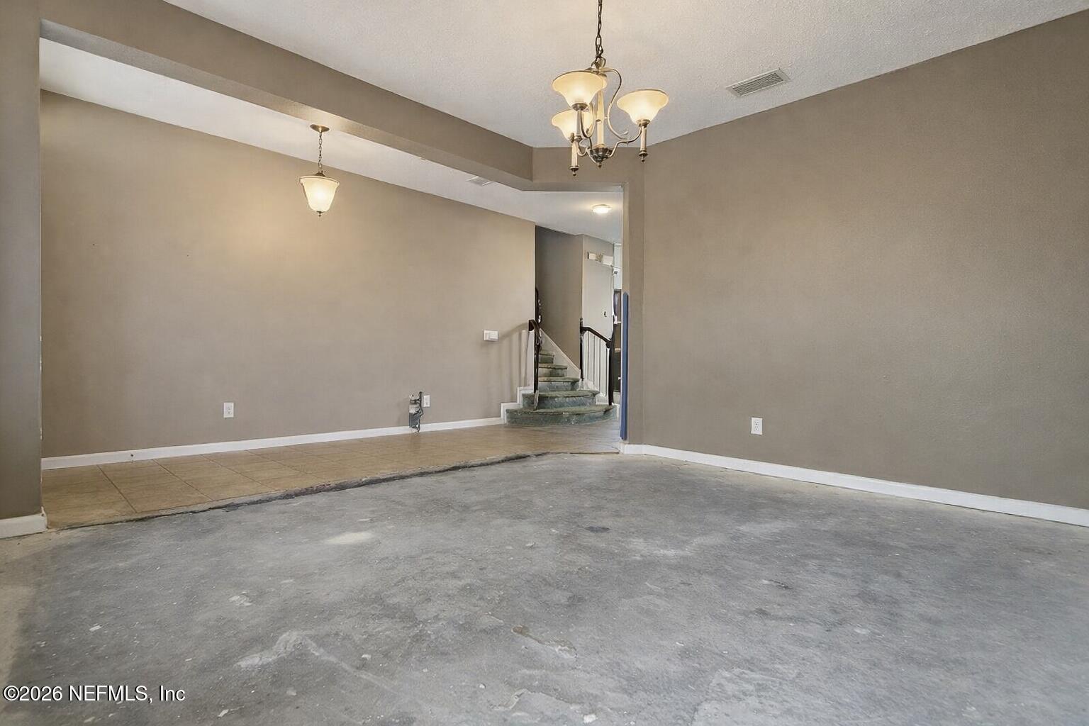 217 Amber Ridge Road Jacksonville, FL 32218 - Photo 6 of 42 a view of an empty room with a chandelier