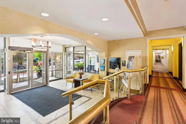 a living room with furniture a dining table and a chandelier