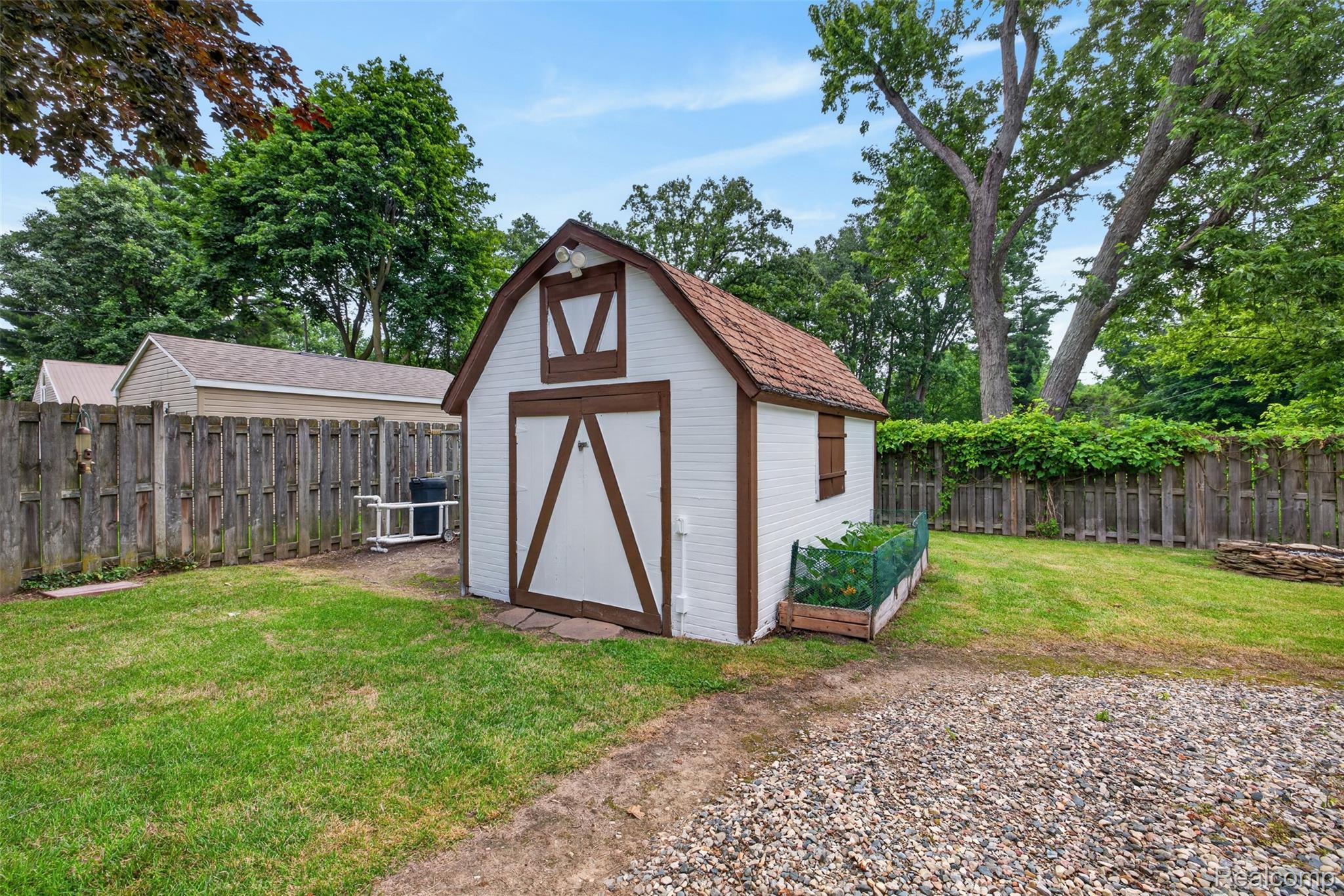 5977 Anglers Road Ortonville, MI 48462 - Photo 58 of 63 Detached barn-style shed featuring a gable roof, double doors, and a side window
