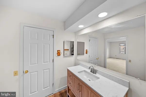a bathroom with a sink a mirror and a shower